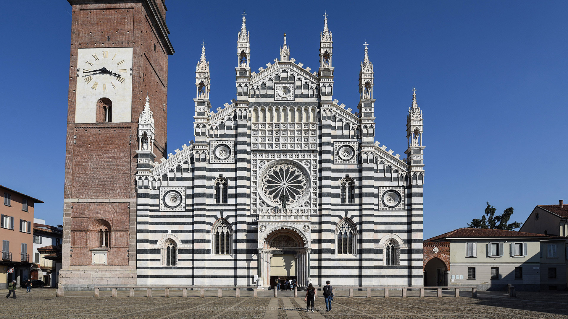 One-Day Monza Itinerary - From the Medieval Centre to the Royal Villa and Park 2 Basilica of San Giovanni Battista in Monza with its marble façade and bell tower under a clear blue sky