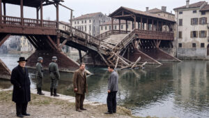 Historical reconstruction of the damaged Ponte degli Alpini in Bassano del Grappa in February 1945, with German soldiers and Italian civilians.