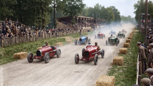 1920s Grand Prix cars racing past spectators and hay-bale barriers at Monza Circuit