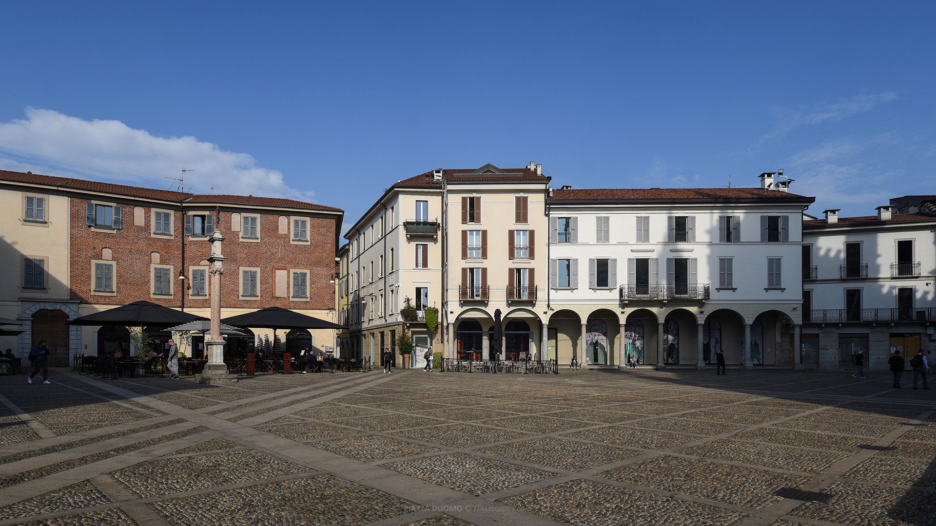 One-Day Monza Itinerary - From the Medieval Centre to the Royal Villa and Park 1 Monza itinerary - Piazza Duomo in Monza with historic residential buildings and arcades around the square